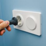 Inserting power cord receptacle in wall outlet